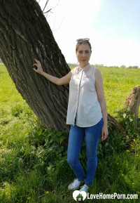 Sexy mom shows off by the tree