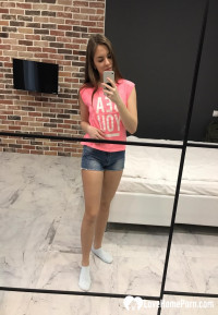 Horny teen plays with her phone while flashing