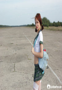 Incredible mom in a schoolgirl outfit posing outdoors