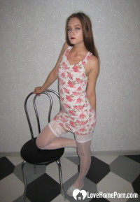 Brunette showing off her tattooed leg in stockings