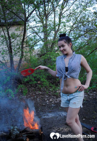 Barbecuing makes her hot so she strips